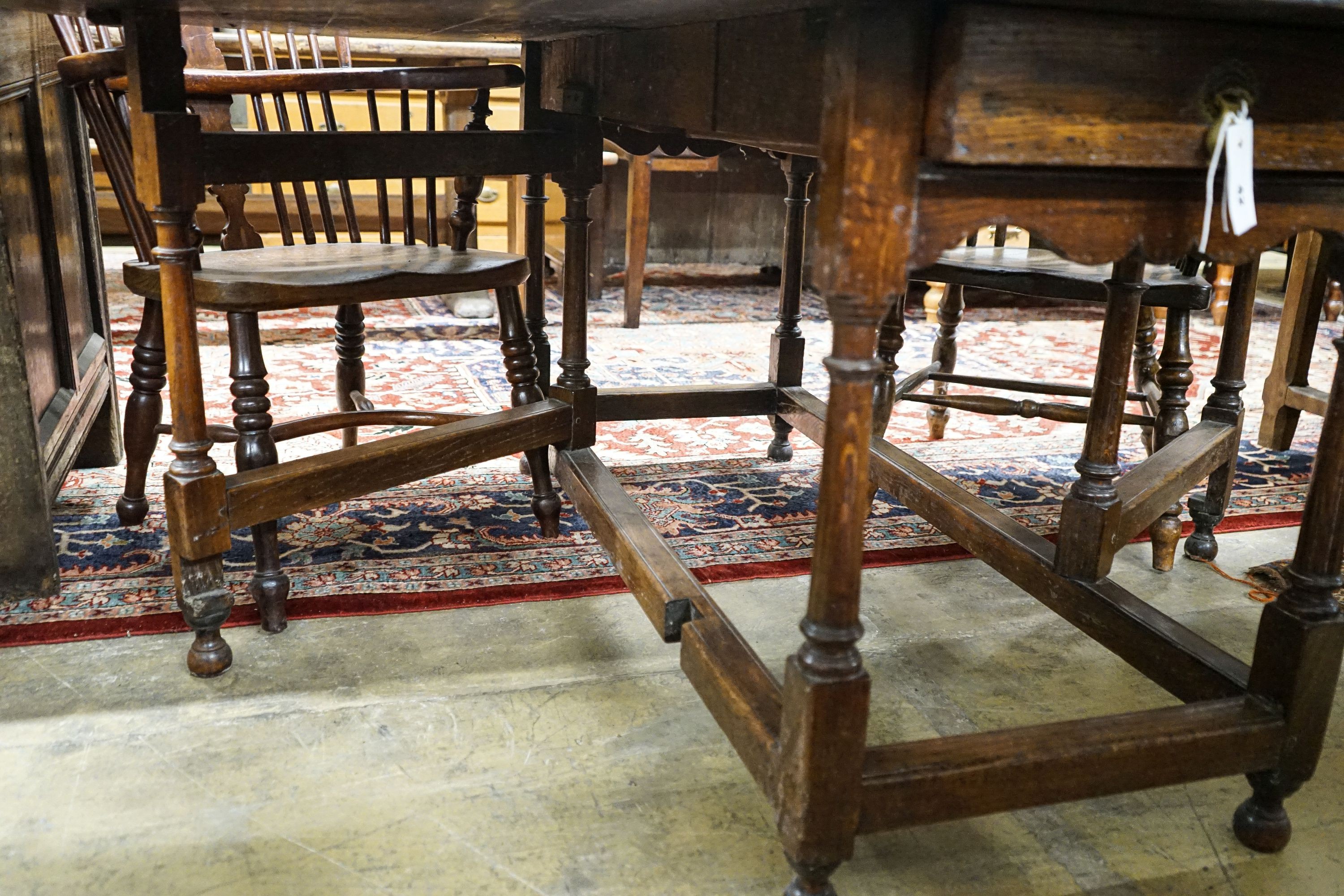 A 17th century style oak gateleg table, with oval top and two frieze drawers, open to 170cm, width 148cm, height 73cm